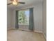 Neutral bedroom with tan carpeting, and window with curtains and treed view at 189 Meadow Spring Dr, Temple, GA 30179