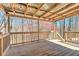 Inviting backyard porch with string lights, wood flooring, and natural railing at 189 Meadow Spring Dr, Temple, GA 30179