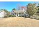 View of a single-story home with stone and siding, complemented by a well-maintained front lawn at 189 Meadow Spring Dr, Temple, GA 30179