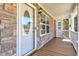 Inviting front porch with a stone facade, white-trimmed windows, and a charming door, enhancing curb appeal at 189 Meadow Spring Dr, Temple, GA 30179
