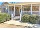 Close-up of a charming front porch with stone accents, white columns, and a well-maintained entrance at 189 Meadow Spring Dr, Temple, GA 30179