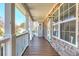 Covered front porch showing stone facade, white railing, wooden floors, and natural light, creating an inviting space at 189 Meadow Spring Dr, Temple, GA 30179