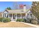 Inviting single-Gathering home with a covered porch, stone accents, manicured bushes, and a well-kept lawn at 189 Meadow Spring Dr, Temple, GA 30179