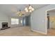 Open living room with fireplace, front door, and view into the kitchen at 189 Meadow Spring Dr, Temple, GA 30179