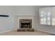 Living room features a stone fireplace, bright window and neutral color palette at 189 Meadow Spring Dr, Temple, GA 30179