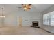 Bright living room with a stone fireplace, carpeted floors and a ceiling fan at 189 Meadow Spring Dr, Temple, GA 30179