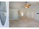 Bright and spacious living room showcasing neutral carpet, high ceilings, a ceiling fan, and ample natural light at 189 Meadow Spring Dr, Temple, GA 30179