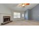 Spacious living room featuring a stone fireplace, bright window, and front door at 189 Meadow Spring Dr, Temple, GA 30179
