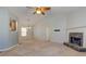 Open-concept living room featuring neutral carpet, a stone fireplace, large windows, and plenty of space to relax at 189 Meadow Spring Dr, Temple, GA 30179
