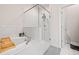 Bright bathroom featuring tiled tub and shower with glass surround at 1949 Skyfall Cir, Brookhaven, GA 30319