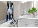 Stylish bathroom featuring a bathtub with shower, toilet and a sink with cabinet at 1949 Skyfall Cir, Brookhaven, GA 30319