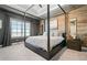 Bedroom with hardwood-look accent wall, a four-poster bed, and ambient lighting at 1949 Skyfall Cir, Brookhaven, GA 30319