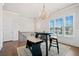 Dining area with an elegant light fixture, wainscotting detail, and natural light at 1949 Skyfall Cir, Brookhaven, GA 30319