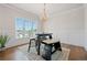 Bright dining room with a modern chandelier, wainscotting, and large windows at 1949 Skyfall Cir, Brookhaven, GA 30319