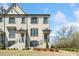 Elegant townhome featuring light brick, a cozy porch, and manicured lawn at 1949 Skyfall Cir, Brookhaven, GA 30319