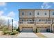 Townhome featuring a drive-under garage, second-floor deck, and neutral exterior paint at 1949 Skyfall Cir, Brookhaven, GA 30319