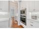 Modern kitchen with stainless steel microwave and oven, white cabinets, and hardwood floors at 1949 Skyfall Cir, Brookhaven, GA 30319