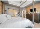 Beautifully designed primary bedroom featuring a barn door, wood accent wall, and tray ceiling at 1949 Skyfall Cir, Brookhaven, GA 30319