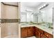 Bathroom featuring double sink vanity, granite countertops, and tiled shower at 2520 Laurel Nw Cir, Atlanta, GA 30311