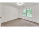 Well-lit bedroom with soft carpet and a large window with green foliage at 2520 Laurel Nw Cir, Atlanta, GA 30311