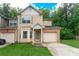 Charming two-story townhome with a well-manicured lawn and attached garage at 2520 Laurel Nw Cir, Atlanta, GA 30311