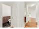 Hallway with hardwood floors that leads to the kitchen and bathroom at 2520 Laurel Nw Cir, Atlanta, GA 30311