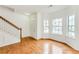 Bright living room featuring hardwood floors, large windows, and a staircase at 2520 Laurel Nw Cir, Atlanta, GA 30311