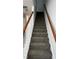 Carpeted staircase with wood railing at 2520 Laurel Nw Cir, Atlanta, GA 30311