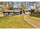 Charming two-story home with a well-manicured lawn and inviting walkway at 5505 Longmeadow Ln, College Park, GA 30349