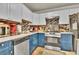 Well-equipped kitchen featuring blue cabinets, stainless steel appliances, and tile backsplash at 5505 Longmeadow Ln, College Park, GA 30349