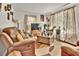 Inviting living area featuring a comfortable sofa, wooden accents, and decorative plants at 5505 Longmeadow Ln, College Park, GA 30349