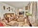 Comfortable living room with a plush brown sofa, cozy decor, and natural lighting at 5505 Longmeadow Ln, College Park, GA 30349