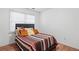 A simple bedroom with a striped comforter on the bed with throw pillows at 109 Bowen Sw Cir, Atlanta, GA 30315
