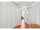 Hallway with hardwood flooring, ample closet space, and leads to a bedroom at 109 Bowen Sw Cir, Atlanta, GA 30315