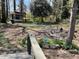 Secluded backyard featuring a deck, shed, and mature trees at 1271 Sanders Dr, Lake City, GA 30260