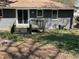 The backyard features a deck, gray painted brick, and mature trees at 1271 Sanders Dr, Lake City, GA 30260