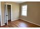 This bedroom has hardwood floors, a closet, and a window at 1271 Sanders Dr, Lake City, GA 30260