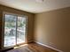 Sunlit bedroom boasts hardwood floors and a sliding door to the deck at 1271 Sanders Dr, Lake City, GA 30260