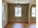 Bright dining room features hardwood floors, neutral walls and a modern chandelier at 1271 Sanders Dr, Lake City, GA 30260