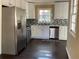 Modern kitchen features stainless steel appliances, white cabinets, and sleek countertops at 1271 Sanders Dr, Lake City, GA 30260