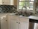 Close-up of the kitchen sink area, showcasing the modern faucet and stylish backsplash at 1271 Sanders Dr, Lake City, GA 30260