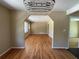 Open-concept living room with hardwood floors and a large archway into another room at 1271 Sanders Dr, Lake City, GA 30260