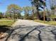 Street view featuring mature trees lining the road and well-maintained lawns in a residential neighborhood at 1271 Sanders Dr, Lake City, GA 30260