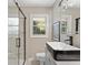 Bathroom featuring a glass shower, modern sink, faucet, and a view of the outdoors at 1703 Derrill Dr, Decatur, GA 30032