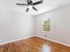 This bedroom offers shiny hardwood floors, neutral paint, a ceiling fan, and plenty of natural light at 1703 Derrill Dr, Decatur, GA 30032