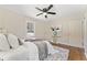 Comfortable bedroom with a queen bed, decorative painting, ceiling fan, and lots of sunlight at 1703 Derrill Dr, Decatur, GA 30032