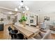 Spacious dining area with a modern light fixture, hardwood floors, and open kitchen access at 1703 Derrill Dr, Decatur, GA 30032