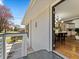 Exterior side view of a gray painted brick home with open glass door, balcony and manicured yard at 1703 Derrill Dr, Decatur, GA 30032