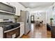 Modern kitchen features stainless steel appliances, white cabinets, and hardwood floors that extend to the dining area at 1703 Derrill Dr, Decatur, GA 30032