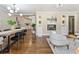 Open-concept living and dining area with hardwood floors, stylish lighting, and fireplace at 1703 Derrill Dr, Decatur, GA 30032
